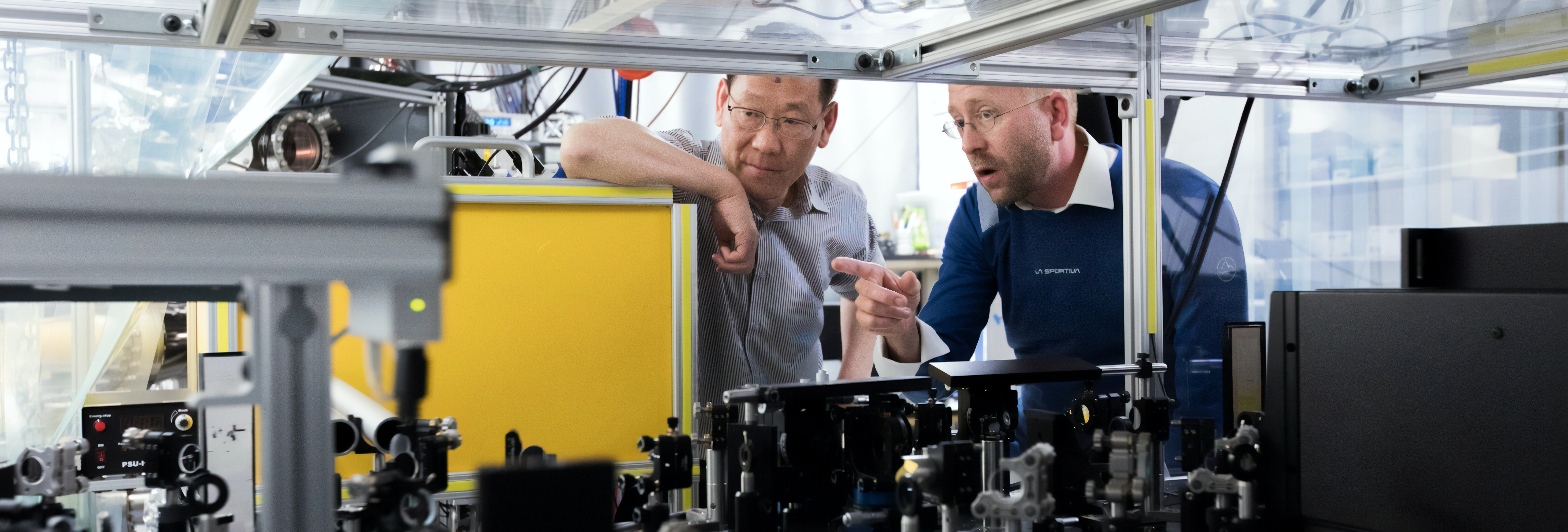 A man teaching another man in a manufacturing plant